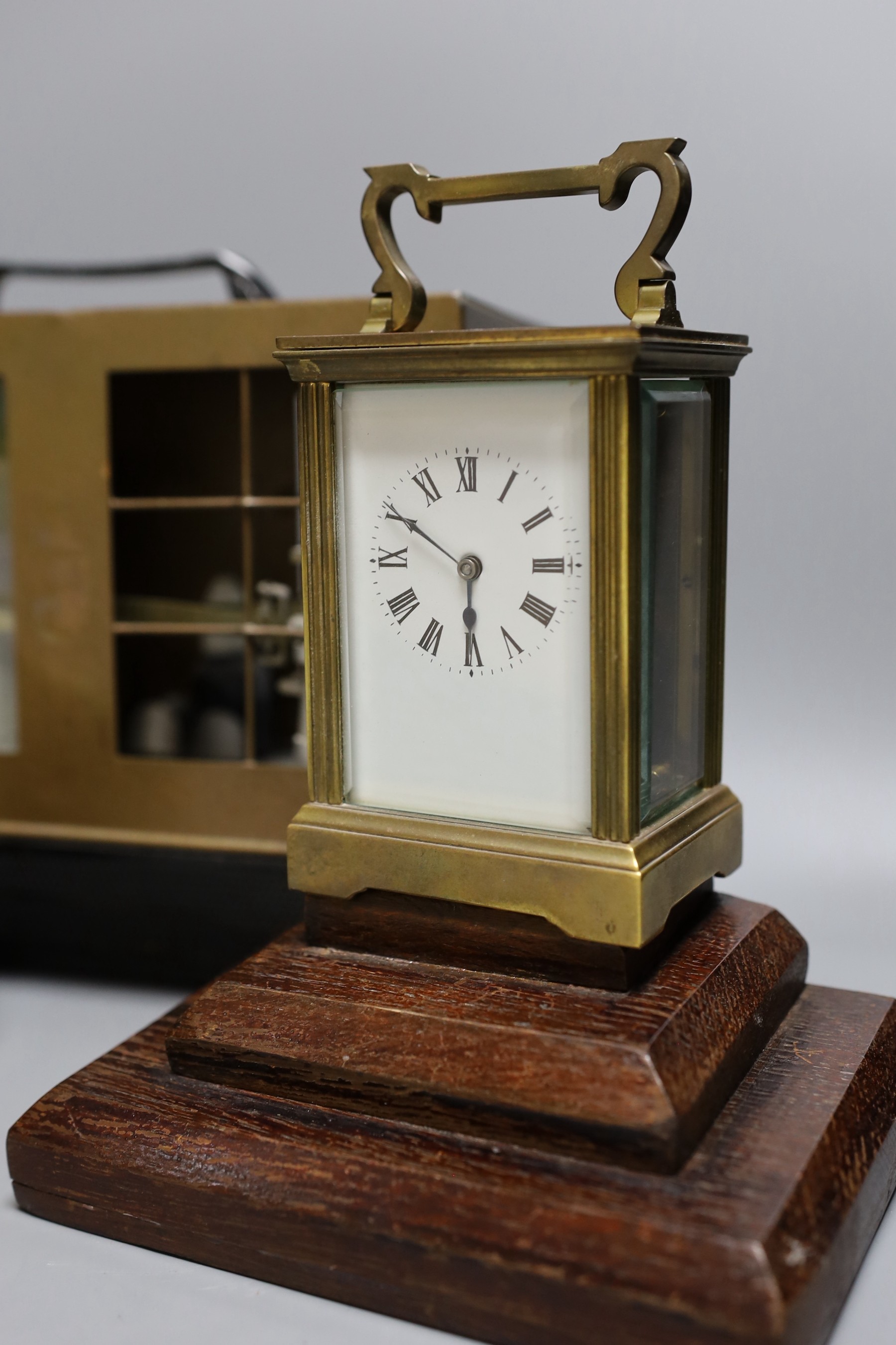 A barograph and three various time pieces including a carriage timepiece, a walnut bracket timepiece and a brass drum timepiece